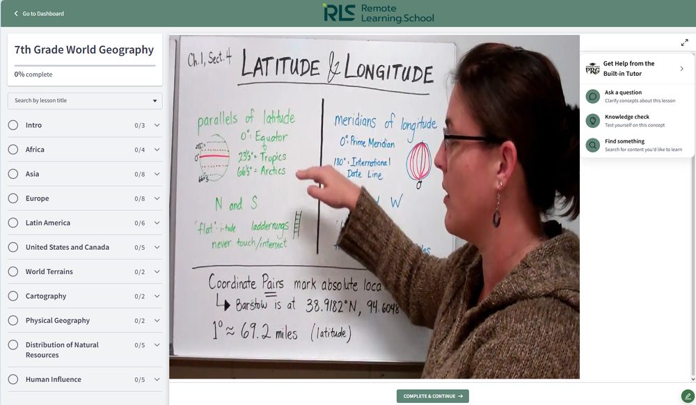 A teacher at the whiteboard explaining latitude and longitude in 7th grade world geography