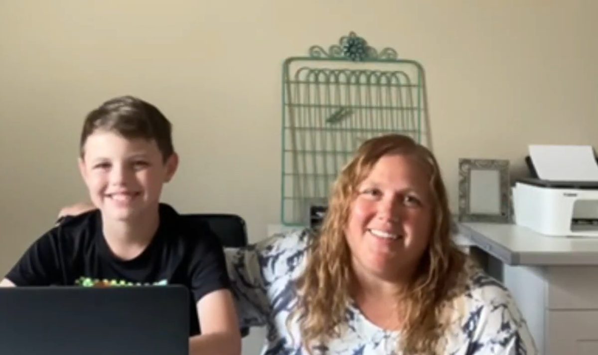 Hayley W. and her son at his laptop, both smiling