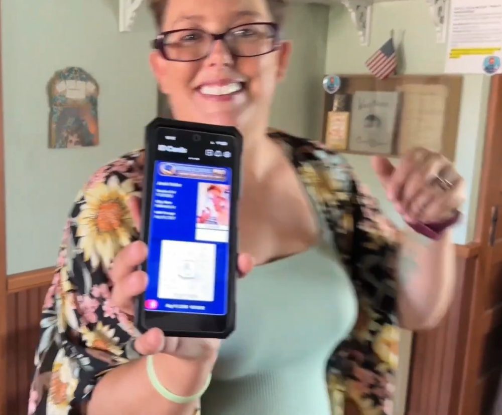 The same Homeschool Pro mom smiling and showing her teacher ID on her phone
